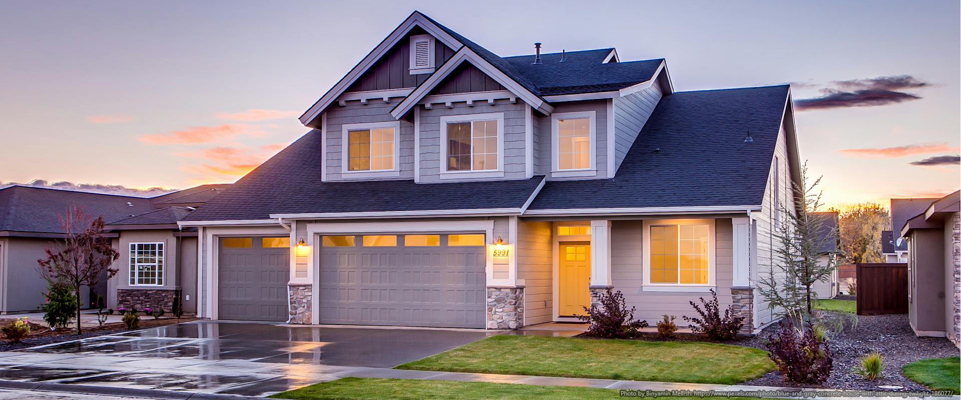 Blue and gray concrete house with attic during twilight